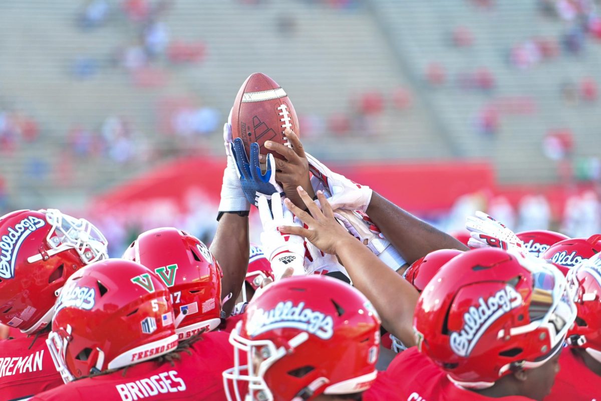 Fresno State football team holds up football on Sept. 7 at Valley Children's Stadium. The team announced Thursday, Sept. 12 that it will be joining the Pac-12 conference. 