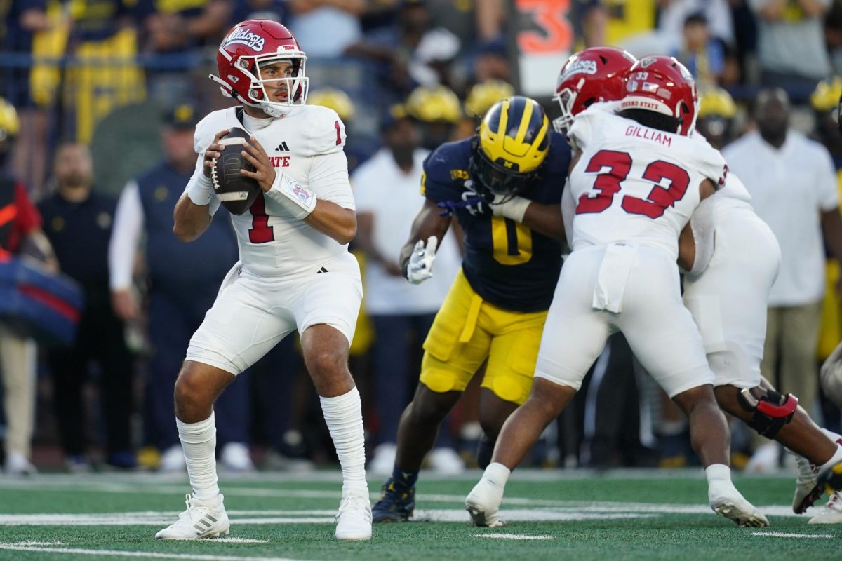 Quarterback Mikey Keene looks downfield in 2024 season opener at Michigan.