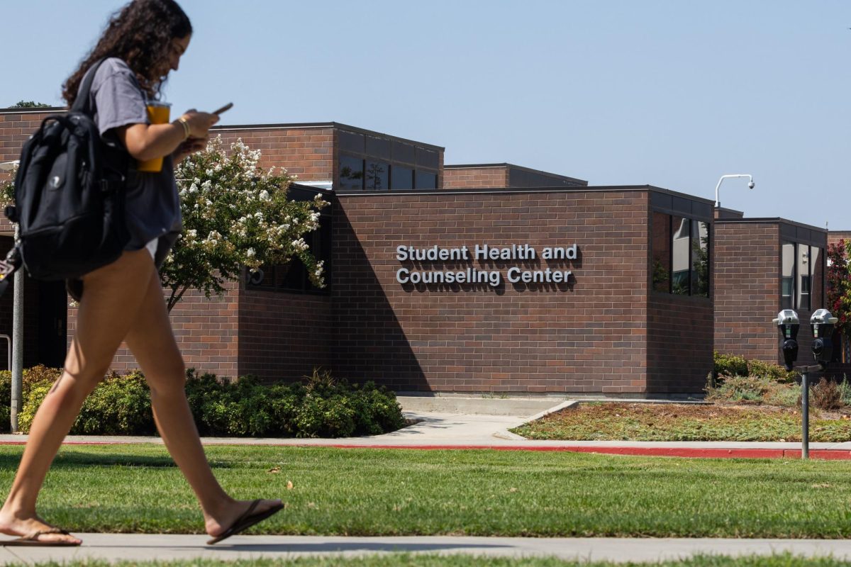 A student walks by the Student Health and Counseling Center. The health center is offering a variety of little to no cost services for students to stay safe during Flu season. 