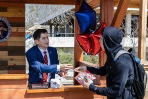 President Saúl Jiménez-Sandoval greets students at his booth.