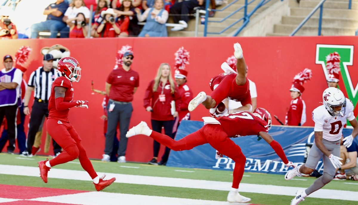 Dean Clark (32) falls over in the end zone after intercepting a ball against the Washington State Cougars on October 12, 2024, at Washington State. 