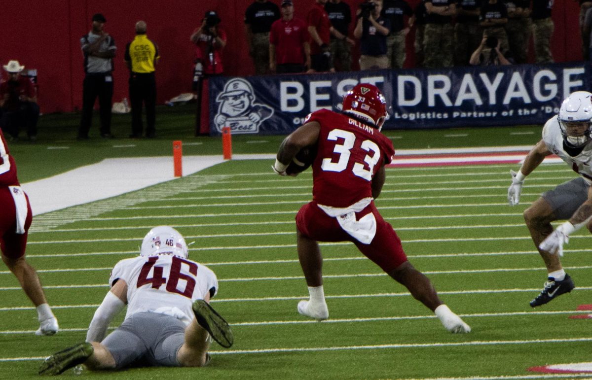 Running back Elijah Gilliam (33) jukes a defender in the third quarter against Washington State on Oct.  12, 2024, at Valley Children's Stadium. 