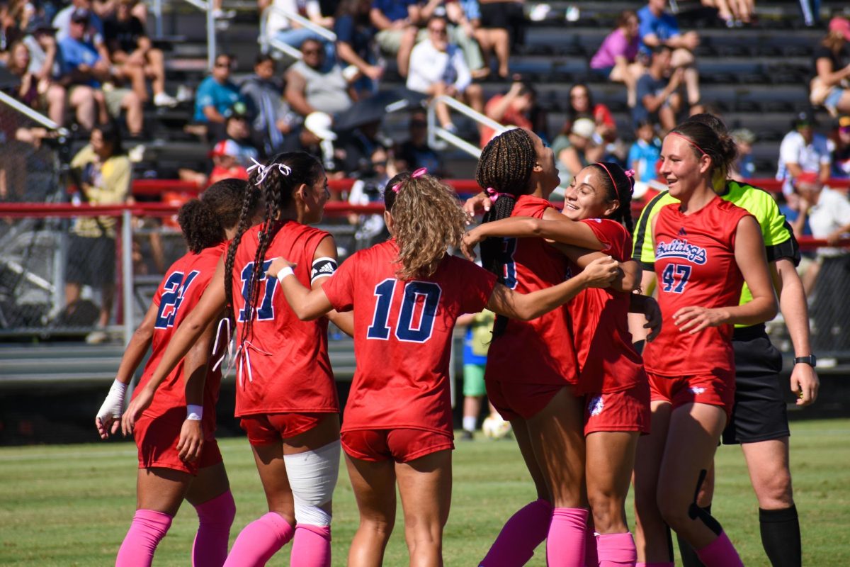 Fresno State women's soccer team celebrates after a goal against the University of Nevada, Reno on Oct. 13 at the Bulldog Soccer Stadium.