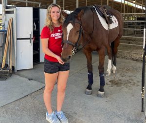 Bridey Jones (left) posing with Dublin, one of the team's horses.