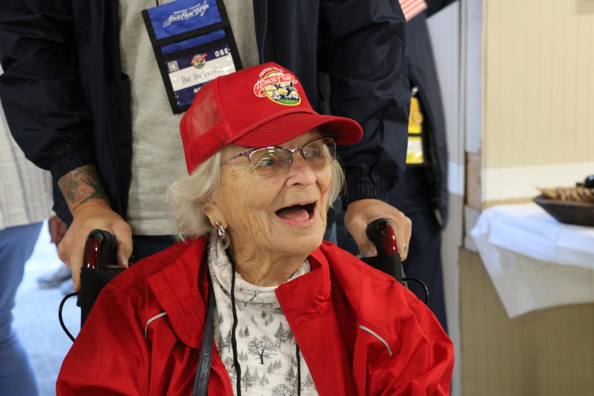 Mel Dockweiler, the only United States Navy veteran woman on flight, smiles as she enters the American Legion Post 276 on Oct. 14. 