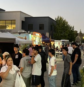 Attendees visiting food trucks at September's Merced Supermrkt