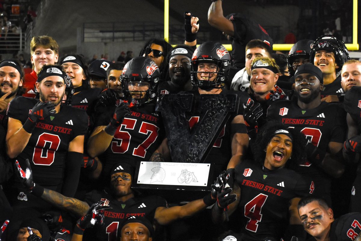 Members of the Fresno State Football team pose with the Valley Trophy after defeating San Jose State 33-10 on October 27,2024, at Valley Children's Stadium. 