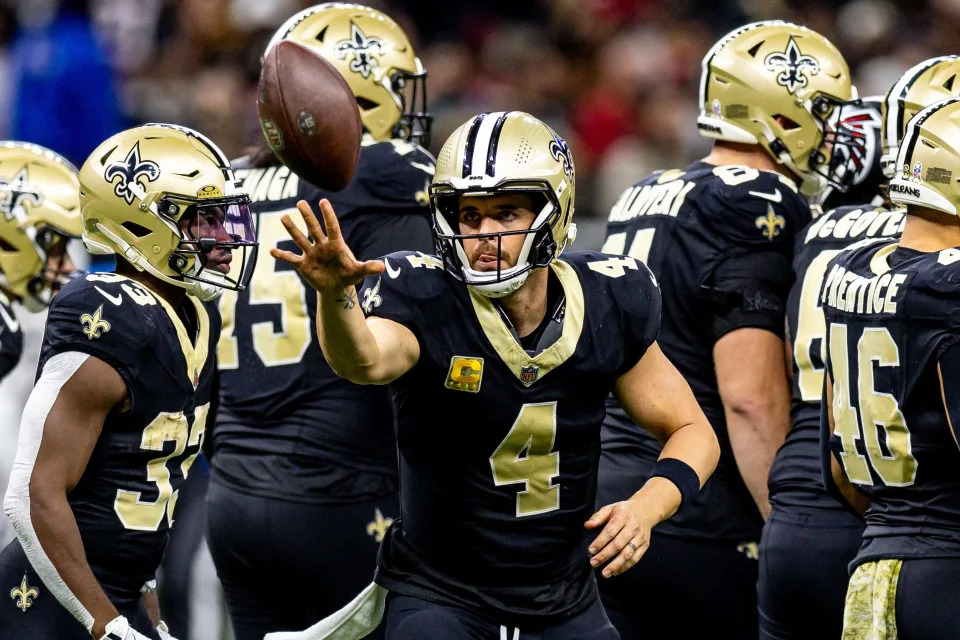 New Orleans Saints quarterback Derek Carr (4) tosses the ball to the referee against the Atlanta Falcons during the first half at Caesars Superdome on Sunday, Nov. 10.