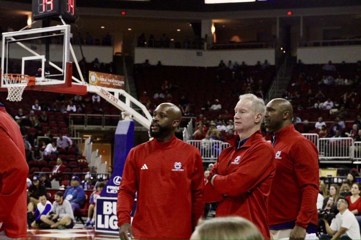 Fresno State assistant coaches Jaren Harris, John Welch and Ray Barefield taking it all in from the bench. 