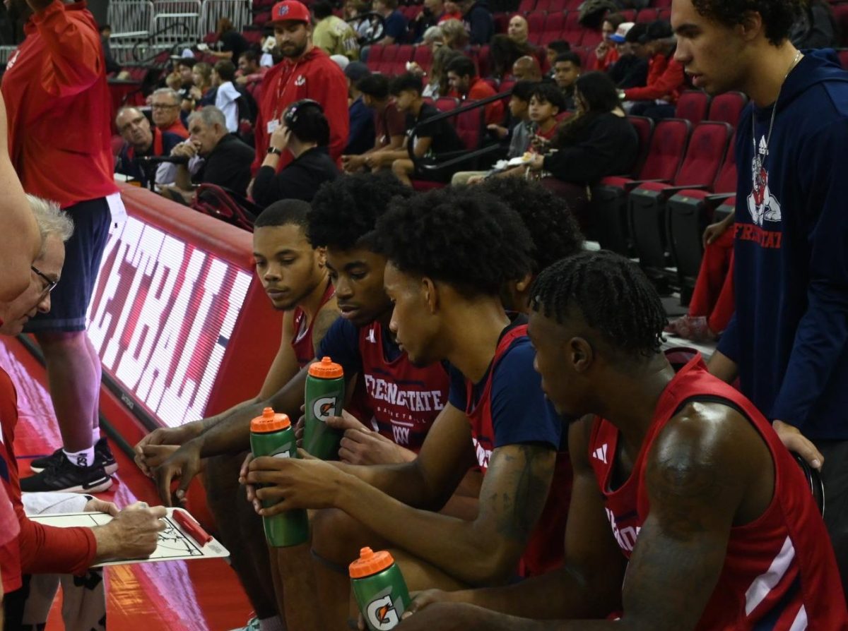 Associate Head Coach John Welch going over the game plan during a timeout at the Red & White scrimmage on Sunday, Nov. 3, at the Save Mart Center. 