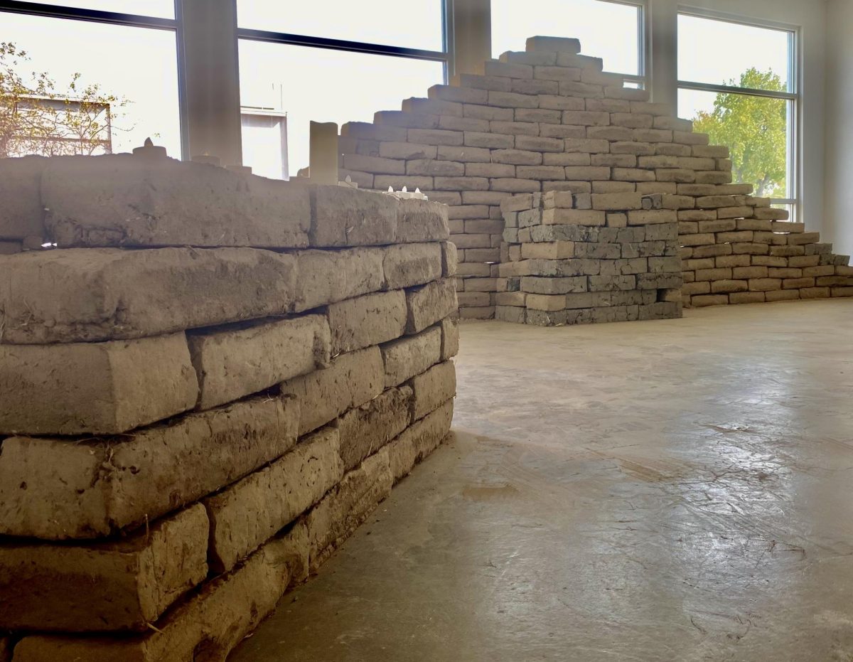 The construction of Fresno State's adobe brick ofrenda begins.