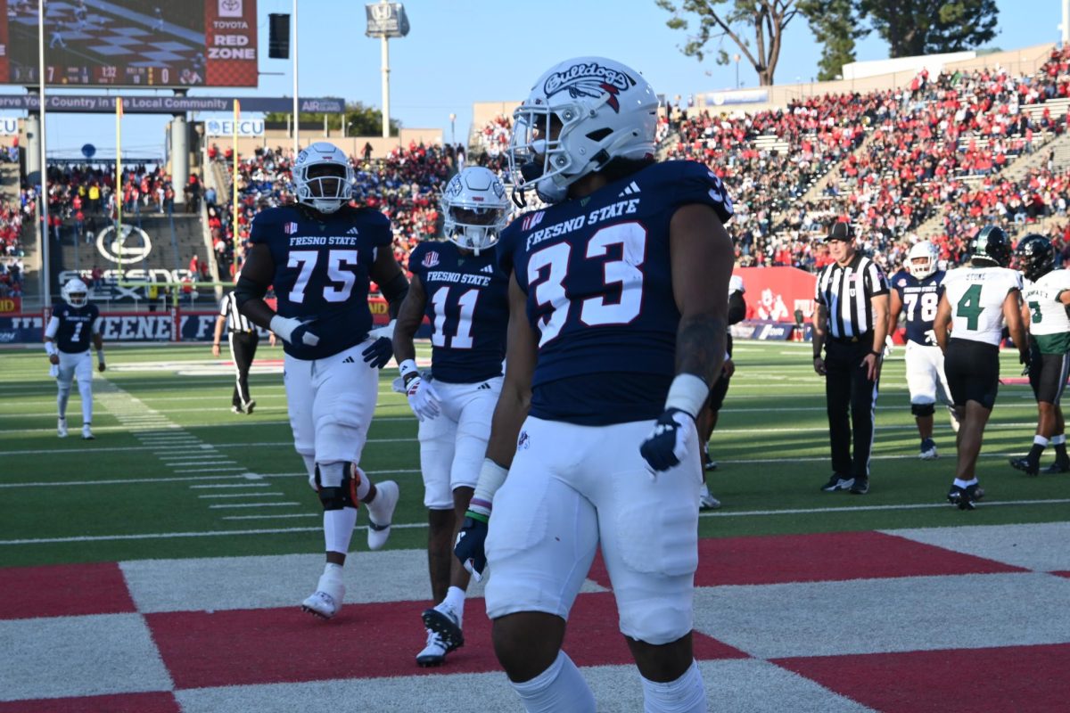 Elijah Gilliam (33) struts after rushing for a 10-yard touchdown in the first quarter. 