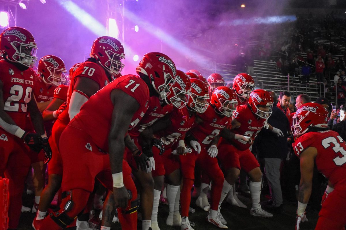 Running back Elijah Gilliam (33) leads the team out onto the field before the win over Colorado State on Saturday, Nov. 23, 2024, at Valley Children's Stadium. 