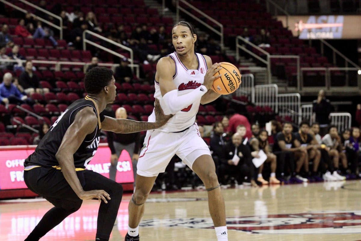 Forward Elijah Price (3) holds ball at the Save Mart Center on Nov. 20. 