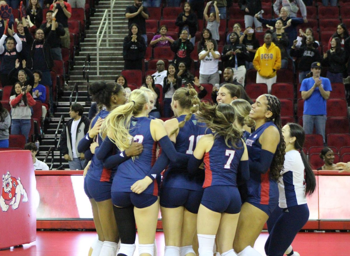 The Fresno State women's volleyball team celebrates clinching a berth for the Mountain West Conference tournament. 