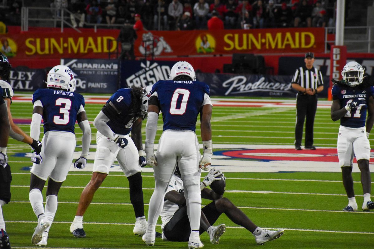 Linebacker Tuasivi Nomura (8) stands over a Hawaii player in the Bulldogs 21-20 loss at Valley Children's Stadium on Saturday, November 2, 2024. 