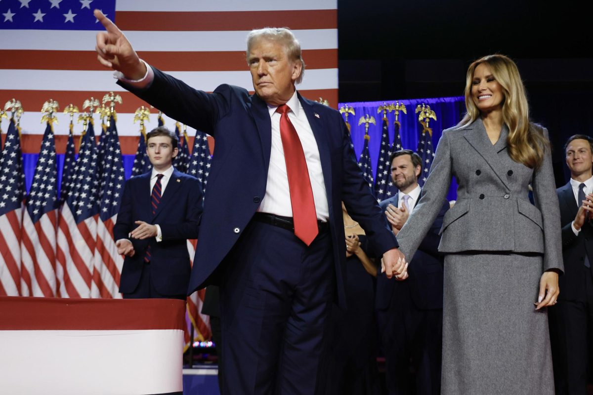 Republican presidential nominee, former U.S. President Donald Trump points to supporters with former first lady Melania Trump during an election night event at the Palm Beach Convention Center on Nov. 06, 2024, in West Palm Beach, Florida. Americans cast their ballots today in the presidential race between Republican nominee former President Donald Trump and Vice President Kamala Harris, as well as multiple state elections that will determine the balance of power in Congress.