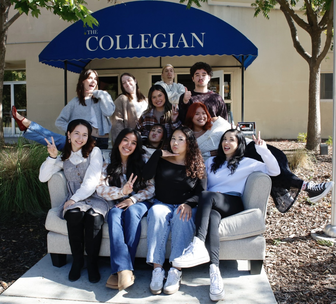 The editorial team of The Collegian poses for a group photo on a couch outside their newsroom.