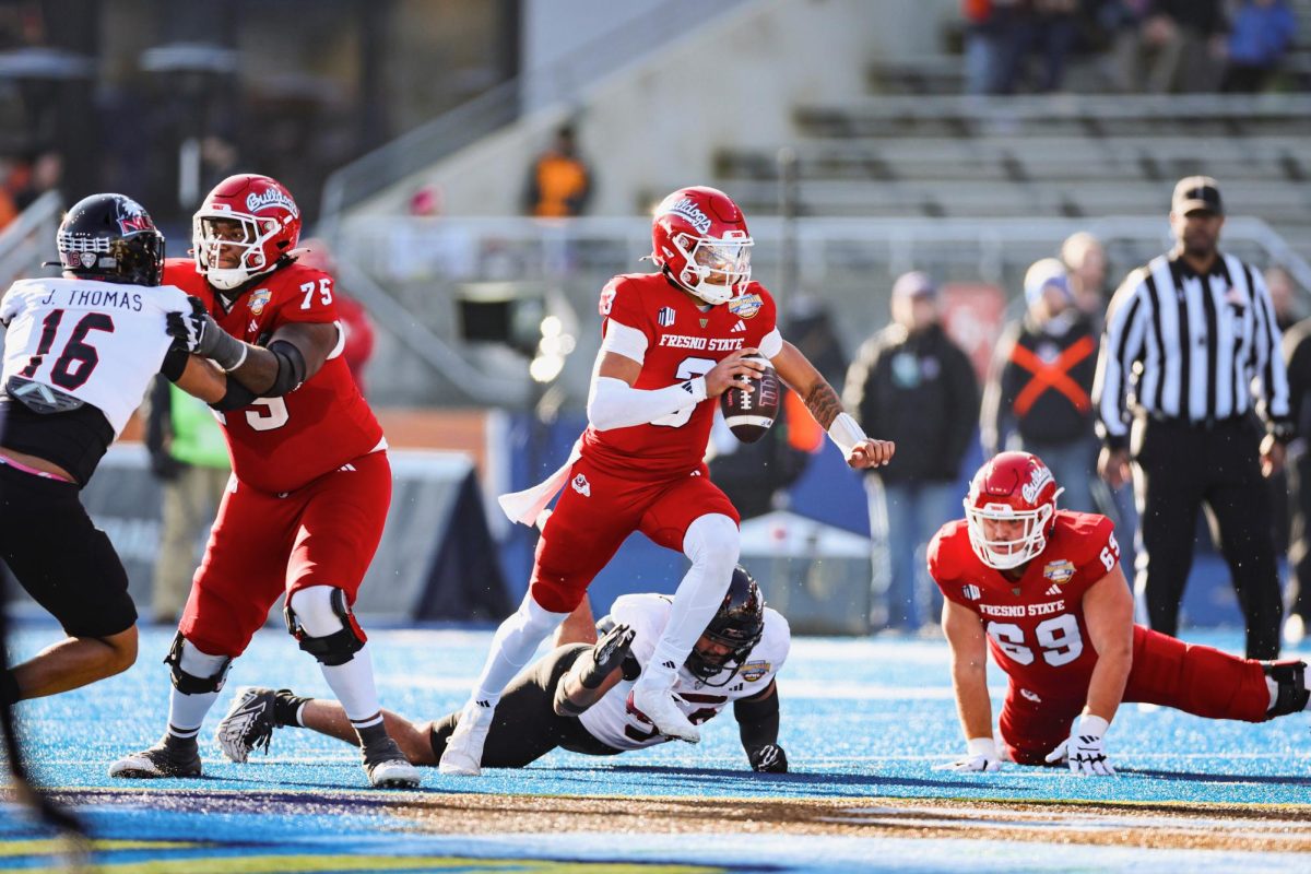 Quarterback Joshua Wood scrambles with the football in Fresno State's 28-20 loss to Northern Illinois at Albertsons Stadium in Boise, Idaho on Monday, Dec. 23, 2024. 