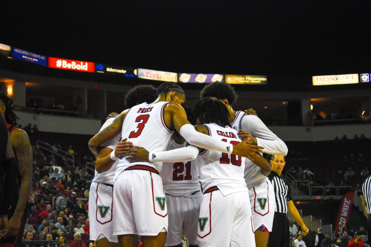 The Fresno State men's basketball team gathers to huddle against San Diego State on Wednesday, Dec. 4, 2024, at the Save Mart Center. 