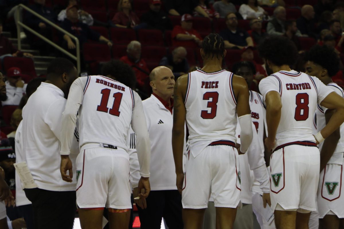 The Fresno State men’s basketball team huddles against San Diego State University on Dec. 4 at the Save Mart Center.