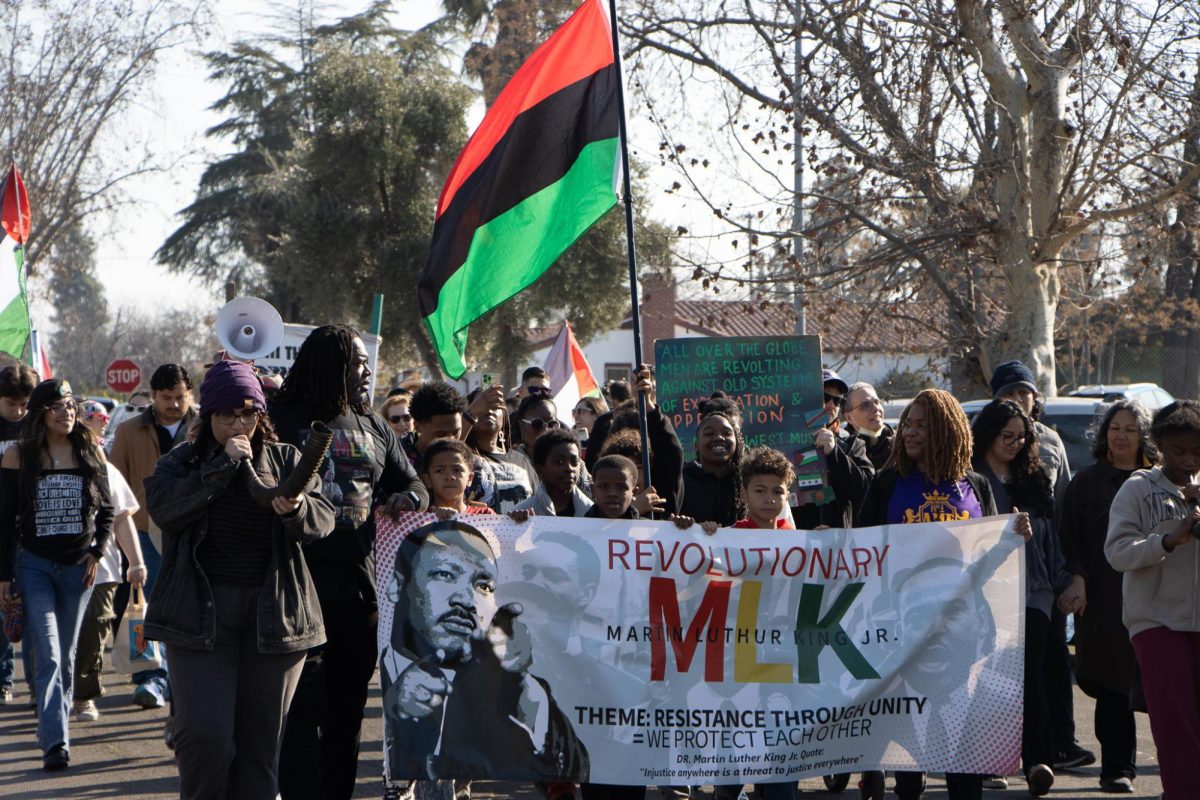 Community members marching in unison down Collins Avenue in West Fresno on Jan. 19.