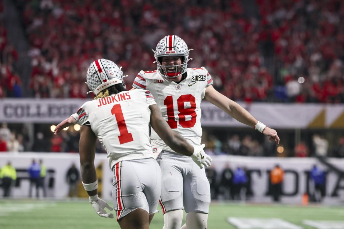 Ohio State quarterback Will Howard (18) celebrates his touchdown pass to running back Quinshon Judkins (1) during the first half against Notre Dame in the 2025 National Championship at Mercedes-Benz Stadium, Monday, Jan. 20, 2025, in Atlanta. Ohio State beat Notre Dame 34-23. 