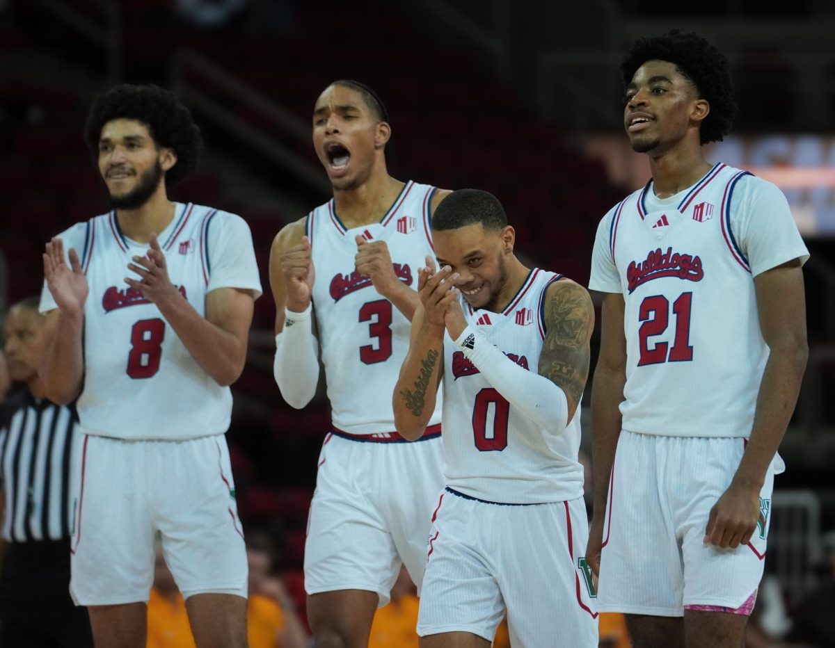 The Fresno State men's basketball team celebrates against the University of Wyoming on March 4 at the Save Mart Center.