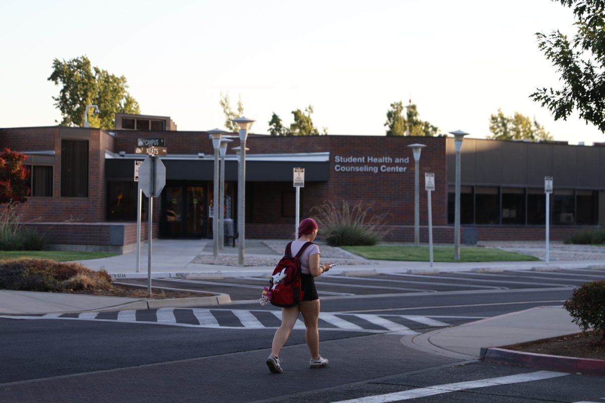 A student walking in front of the Student Health and Counseling Center on Aug. 20. 