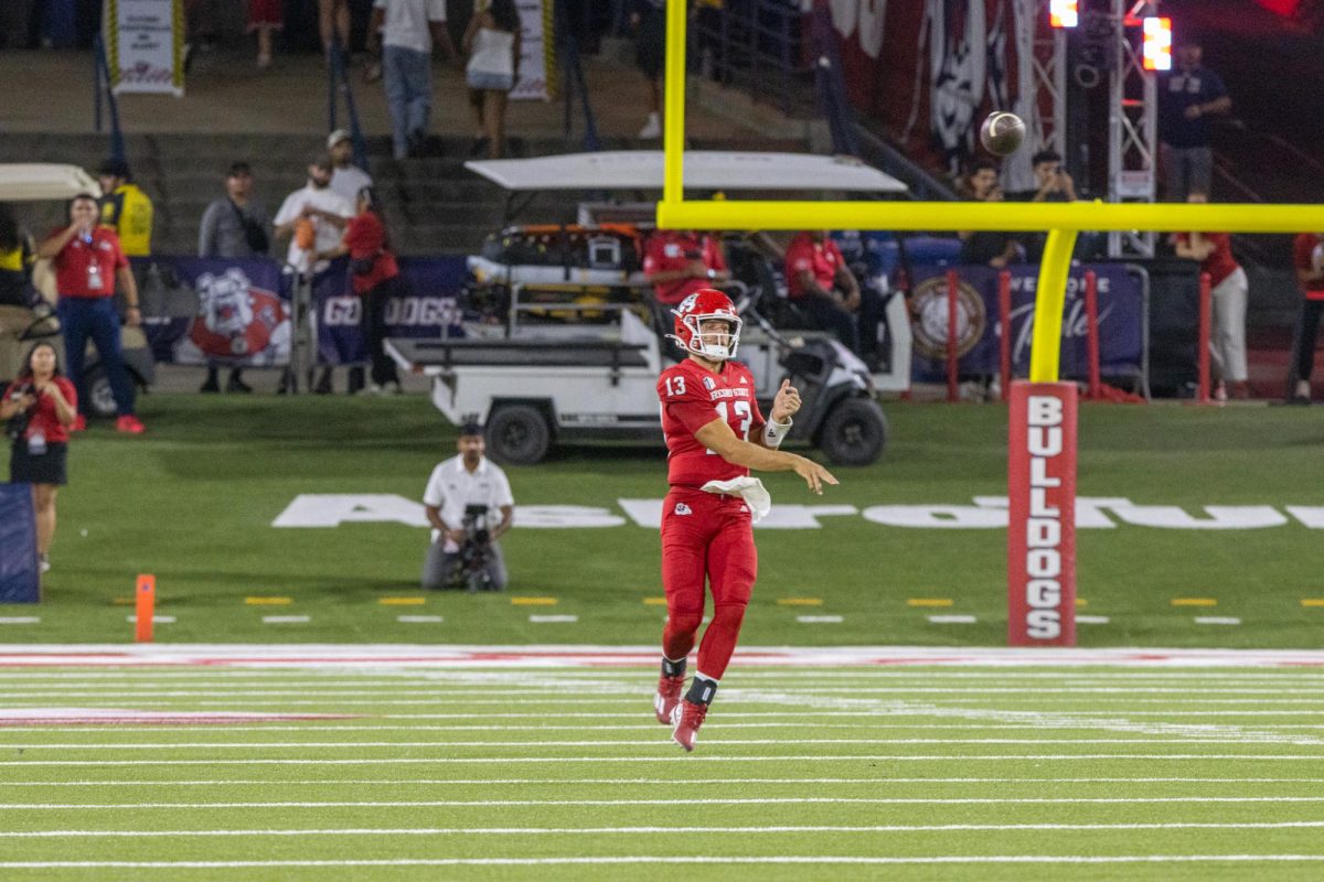 Quarterback E.J. Warner throws on the run.