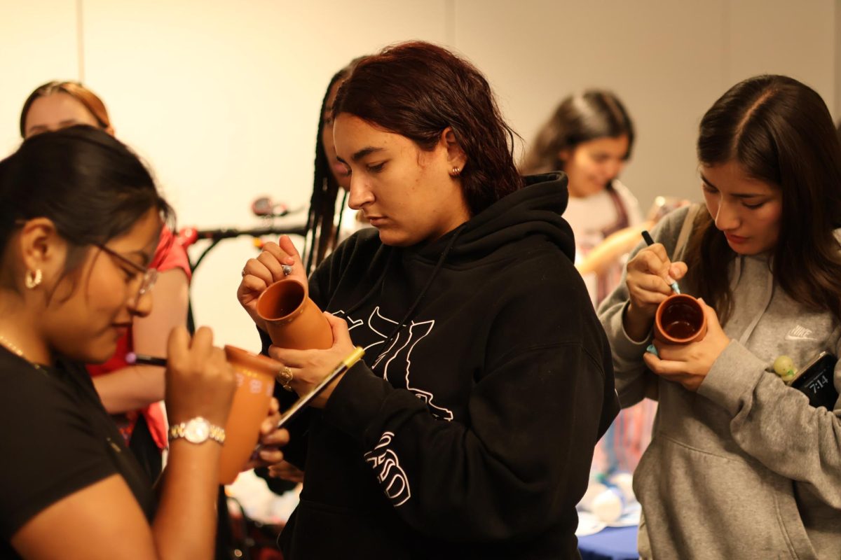 Students paint cantaritos at Viva La Fiesta in the Ruiz Event Space on Sept. 18.