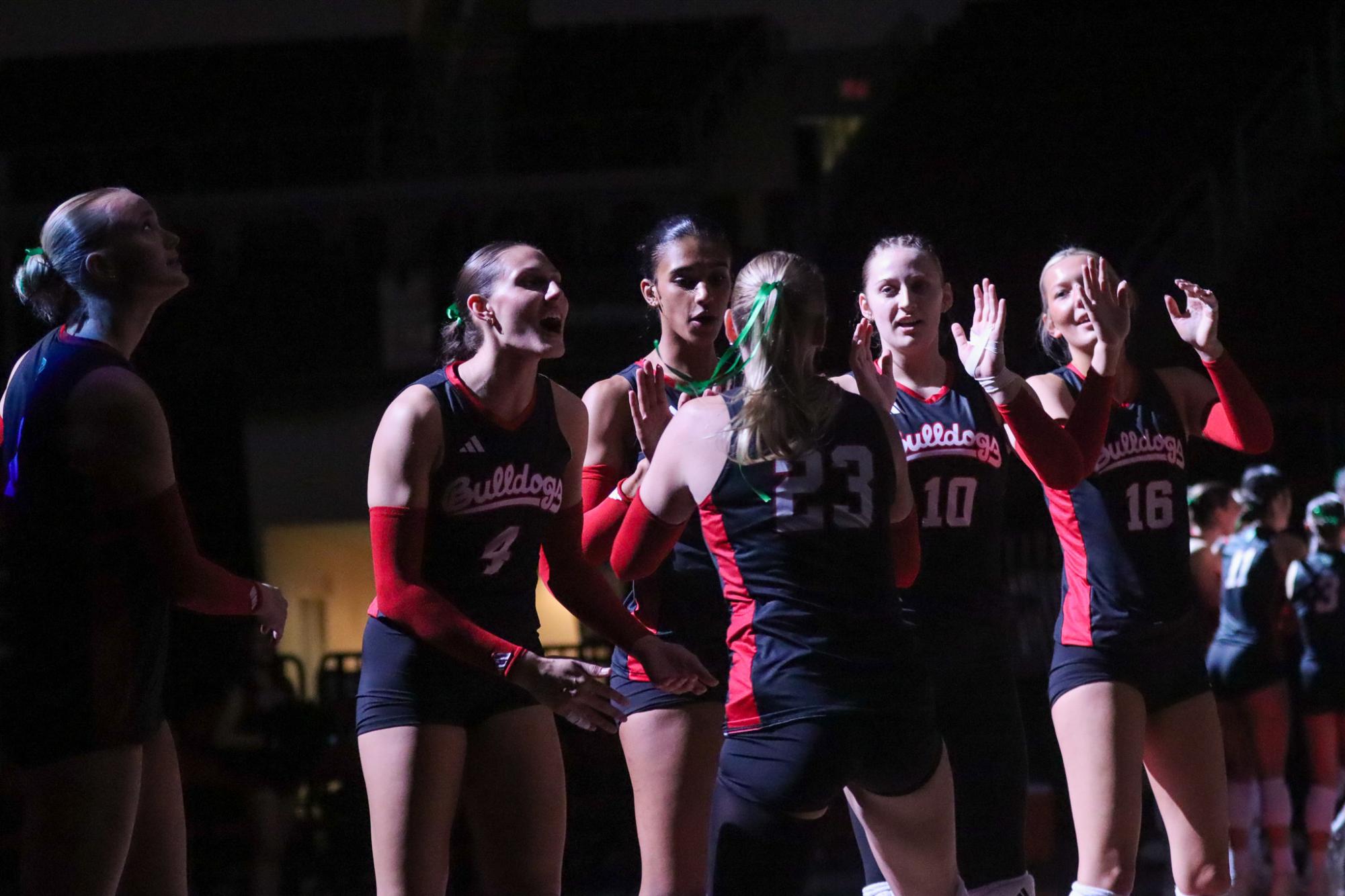 Jenna Legault (23) high-fives her teammates Addison Haluska (4), Brooklyn Washington (7), Alivia Schneider (10) and Addison Williams (16) before the Bulldogs' conference opener against the San Diego State Aztecs on Sept. 25 at the Save Mart Center.