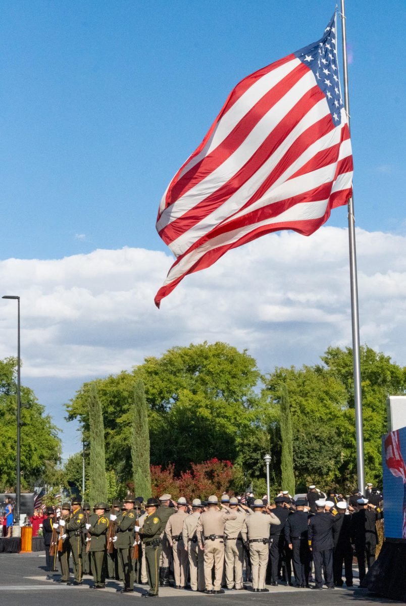 The Fresno Police and Fire Departments along with military personnel salute a half staffed flag at the 9/11 Memorial Remembrance Ceremony in Clovis on Sept. 11.