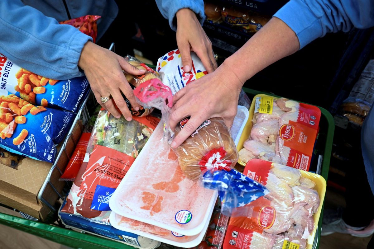 Women select food at the Community Table food pantry, weeks into the continuing U.S. government shutdown, in Arvada, Colorado, U.S. October 22, 2025.  REUTERS/Mark Makela