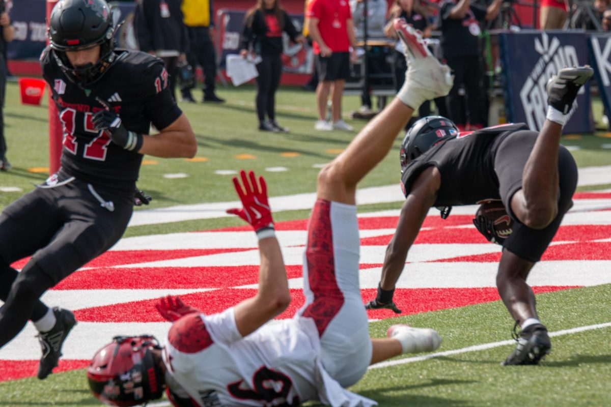 Defensive back Al'zillion Hamilton (3) dives into the end zone after picking off Aztec quarterback Jayden Denegal as Aztec wide receiver Will Cianfrini (16) on Oct. 25 at Valley Children's Stadium