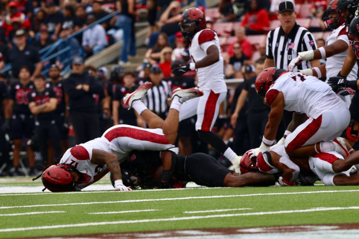 Running back Bryson Donelson is tackled by the San Diego State Aztec defense on Oct. 25 at Valley Children's Stadium. The Bulldogs struggled to run the ball in the first quarter, only gaining 21 yards.