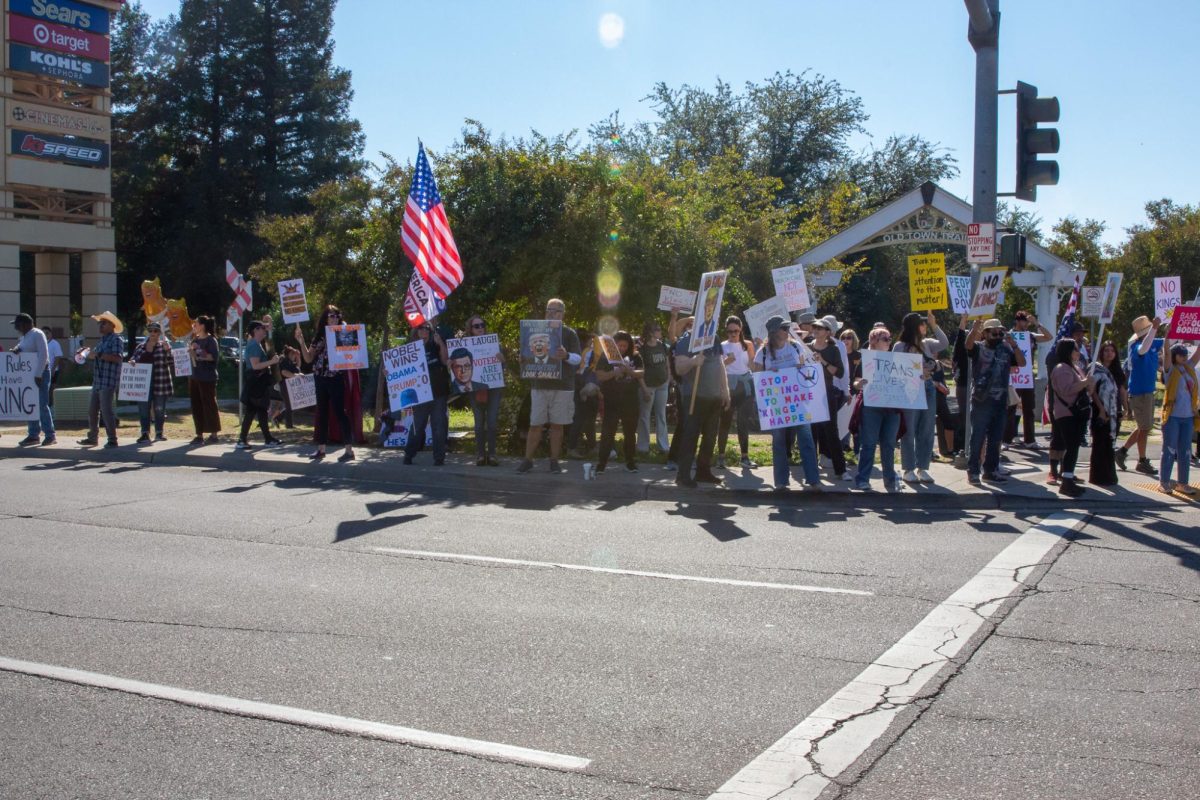 People line up outside Old Town Trail in Clovis in support of No Kings Day on Oct. 18.