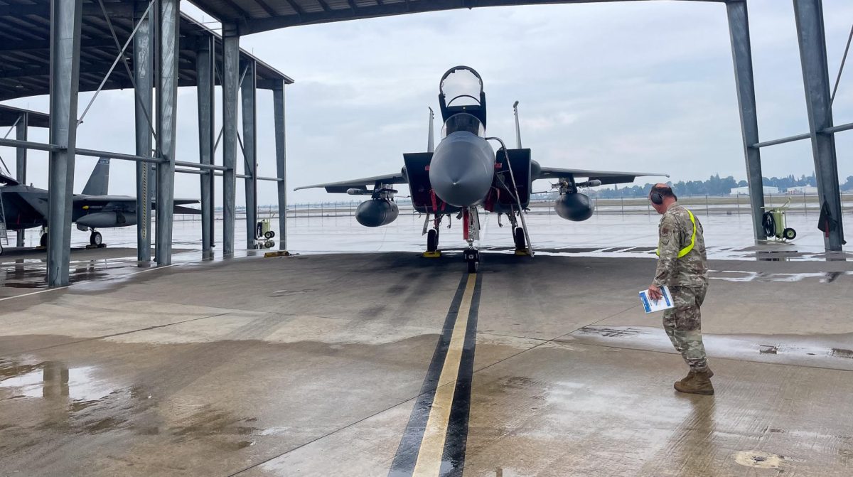 A flight line crew member with the 144th Fighter Wing walks to his station during daily training flights at Fresno's Air National Guard base.  