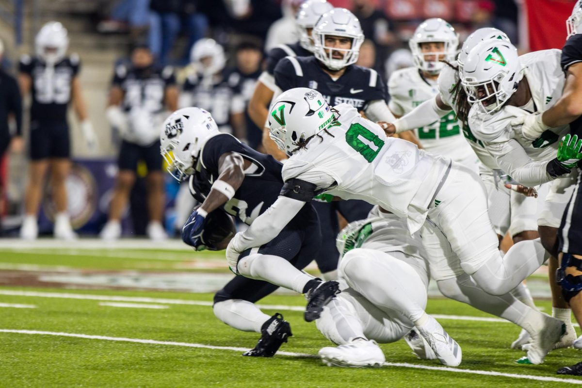 Bulldogs' defensive end Korey Foreman (0) tackles the Aggies running back in the backfield in the second quarter on Nov. 22 at Valley Children's Stadium.