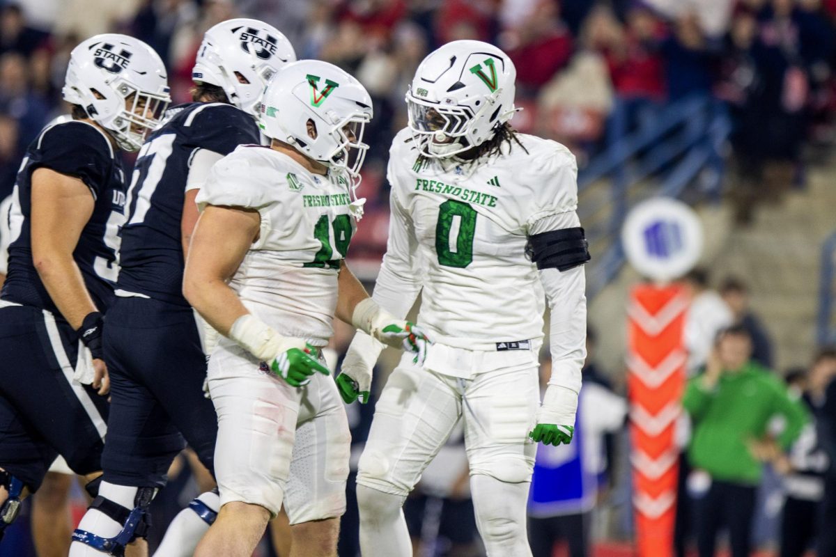 Fresno State senior defensive linemen Finn Claypool (19) and Korey Foreman (0) celebrate after a tackle against the Utah State Aggies at Valley Children's Stadium on Nov. 22.