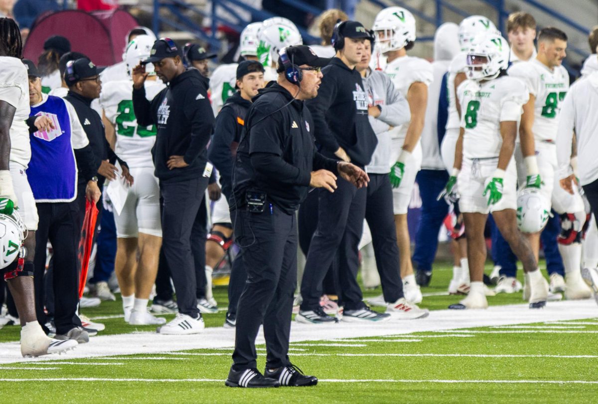 Bulldogs' Head Coach Matt Entz stands near the 50-yard line during a media timeout against the Utah State Aggies on Nov. 22 at Valley Children's Stadium.