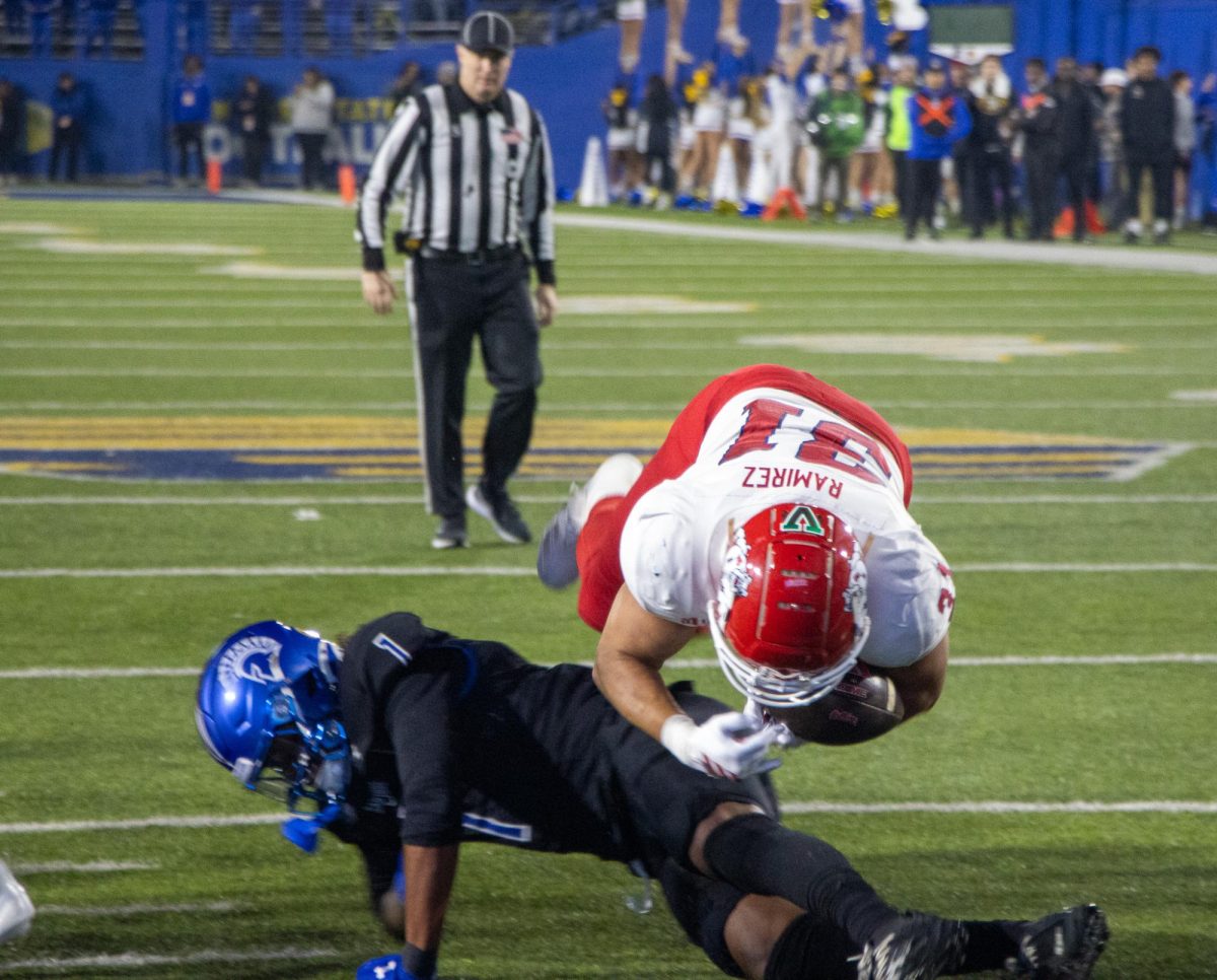 Running back Brandon Ramirez dives into the endzone.