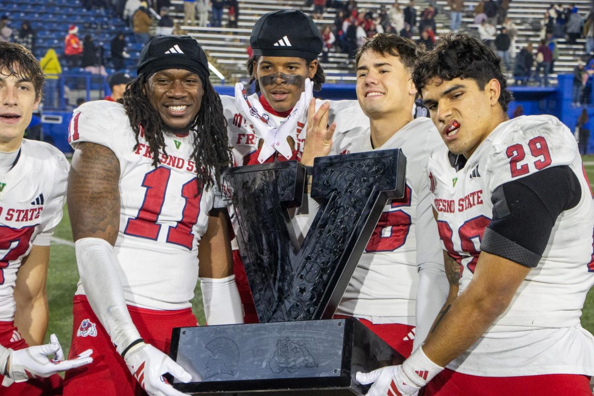 From left to right: Jayden Davis (11), Josiah Freeman, Dylan Lynch (46) and Jaden Carrillo hold the Valley Trophy after defeating the San Jose State Spartans 41-14 on Nov. 29 at CEFCU Stadium
