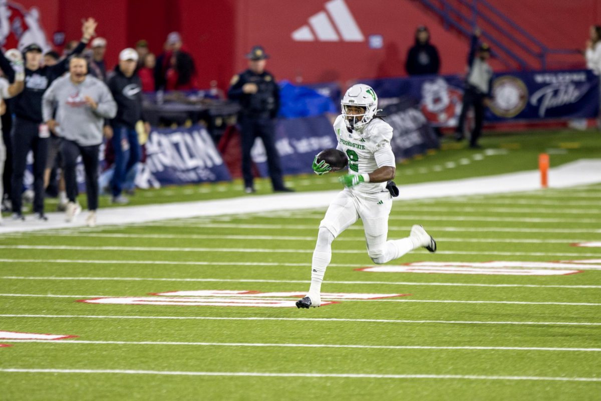 Running back Rayshon Luke runs down the field during his 69-yard rushing touchdown in the first quarter against the Utah State Aggies at Valley Children's Stadium on Nov. 22.