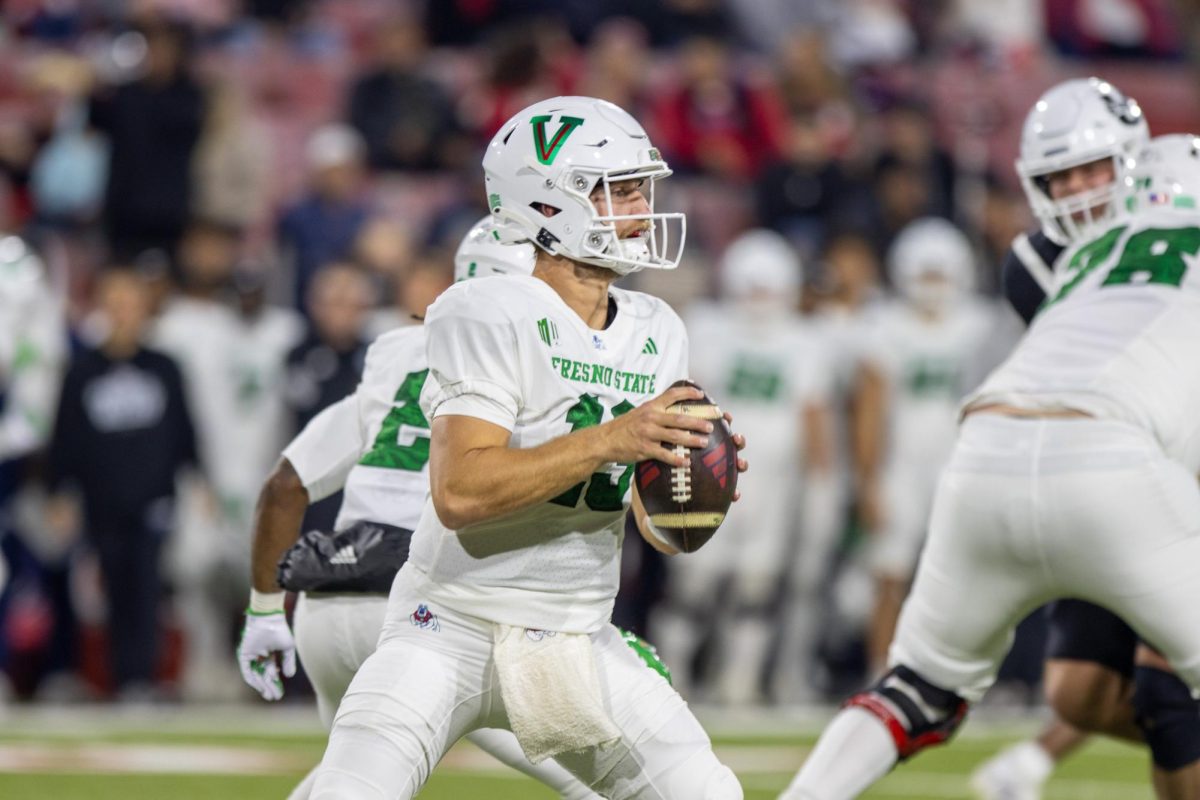 Quarterback E.J. Warner looks to throw against the Aggies in his first game since Oct. 11