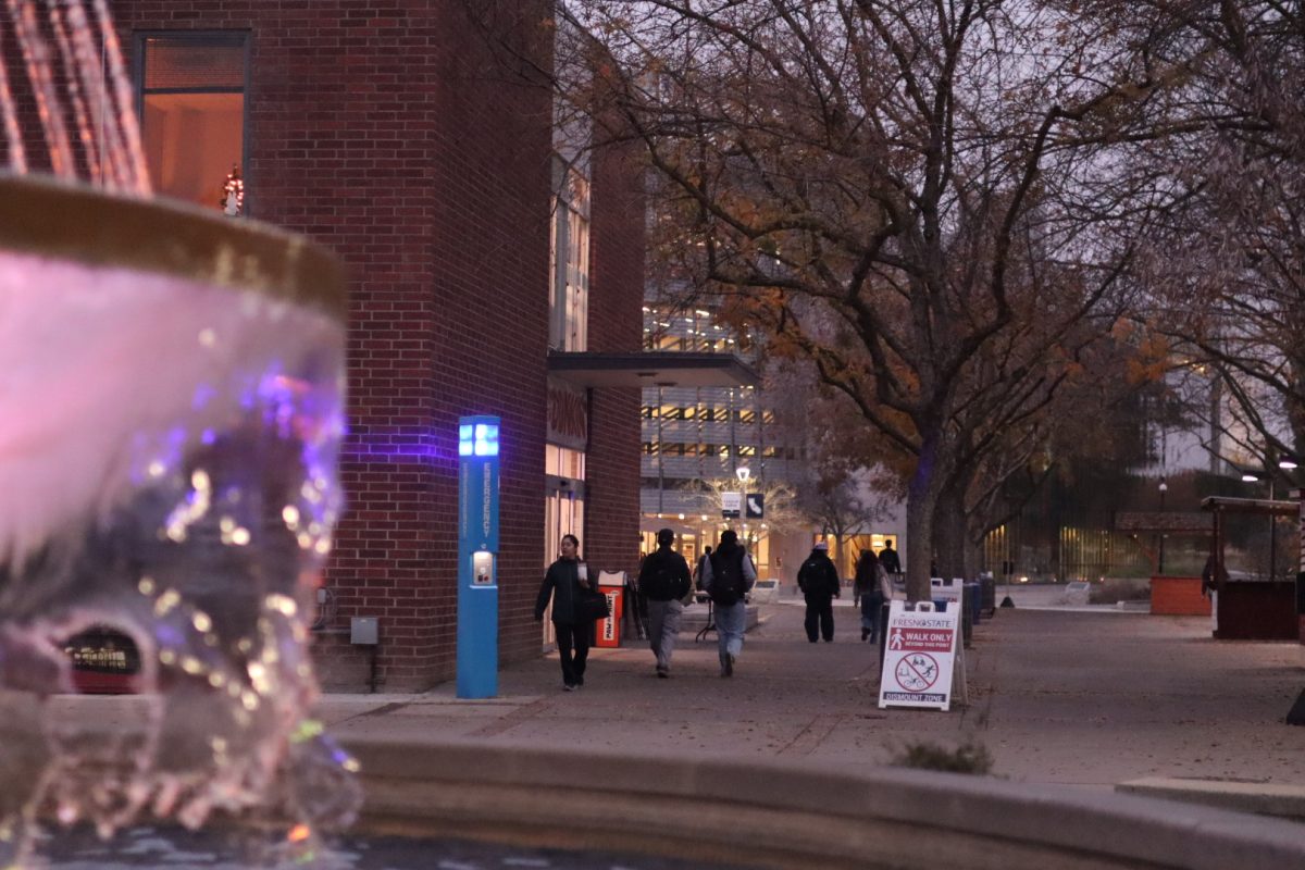 Students walk down the free speech area, west of Memorial Fountain on Dec. 15.