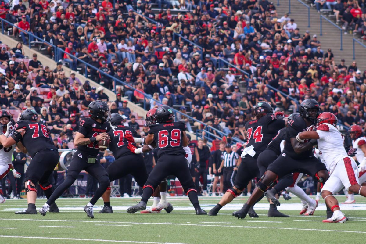 Bulldogs' center Jacob Spomer and the offensive line blocks for quarterback Carson Conklin against the San Diego State Aztec defense on Oct. 25 at Valley Children's Stadium. Spomer became the first Bulldogs' center to be names all-Mountain West first team.