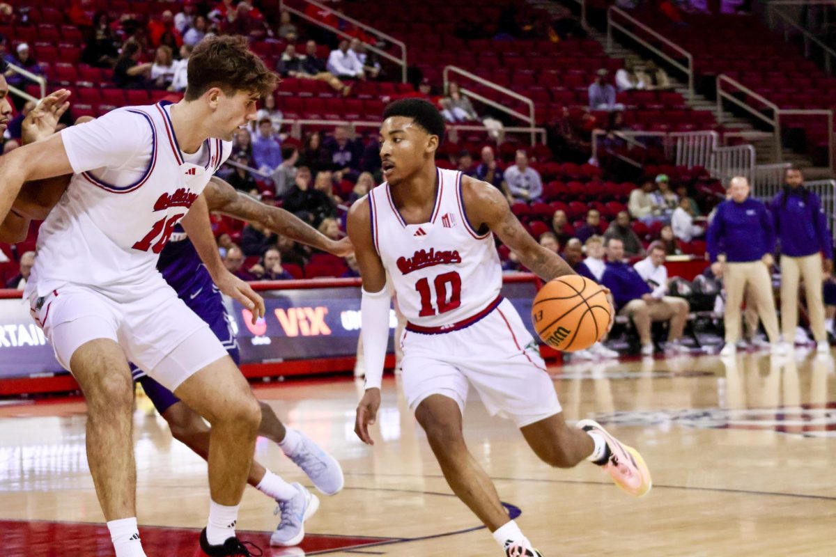 Fresno State guard Zaon Collins (10) dribbles past the elbow as center Wilson Jacques (16) sets a screen on his defender in a game against the Utah State Aggies at the Save Mart Center on Dec. 30.