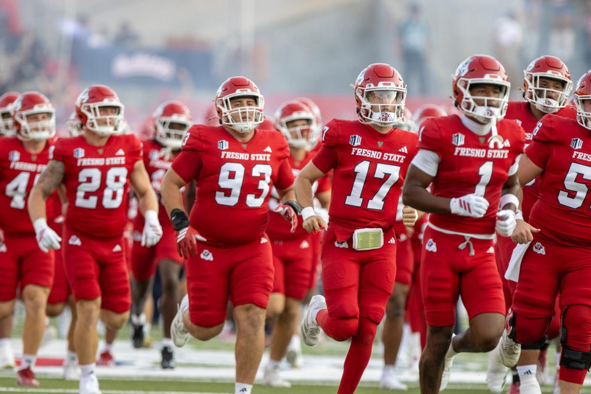 Fresno State football team running onto the field before a game on Aug. 30. 