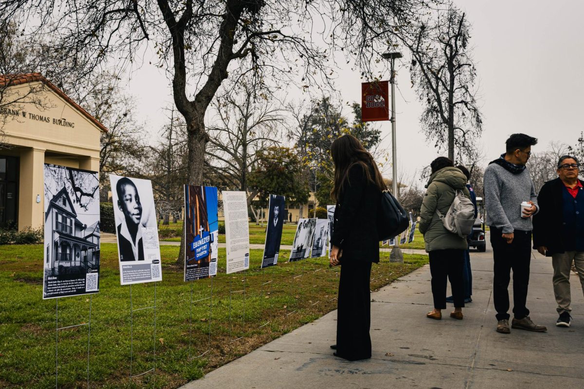 An attendee observes a poster at the on-campus MLK Day commemoration on Jan. 21.